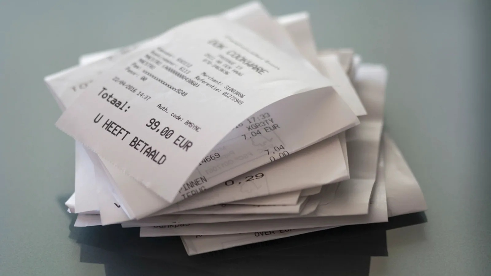 A stack of printed till receipts on a table