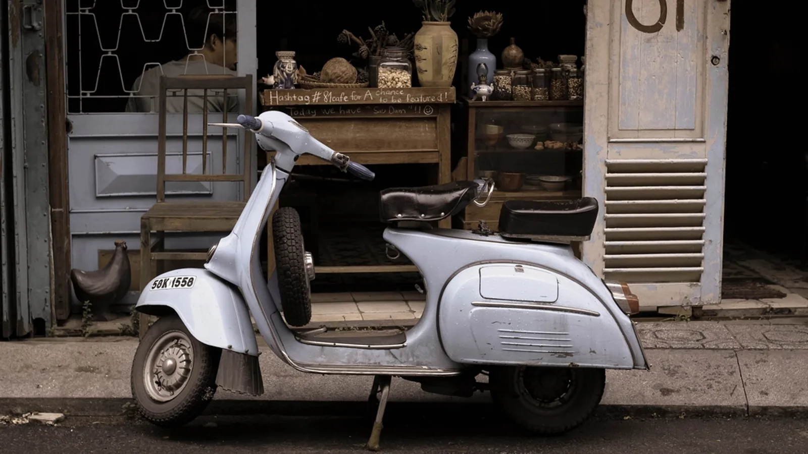 A vintage motor scooter parked on a city street